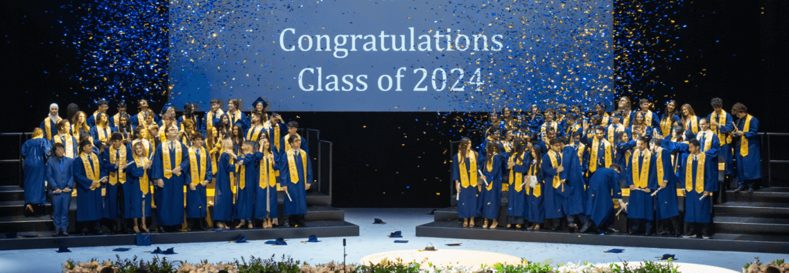 Repton School Dubai students at their graduation ceremony, dressed in blue graduation gowns